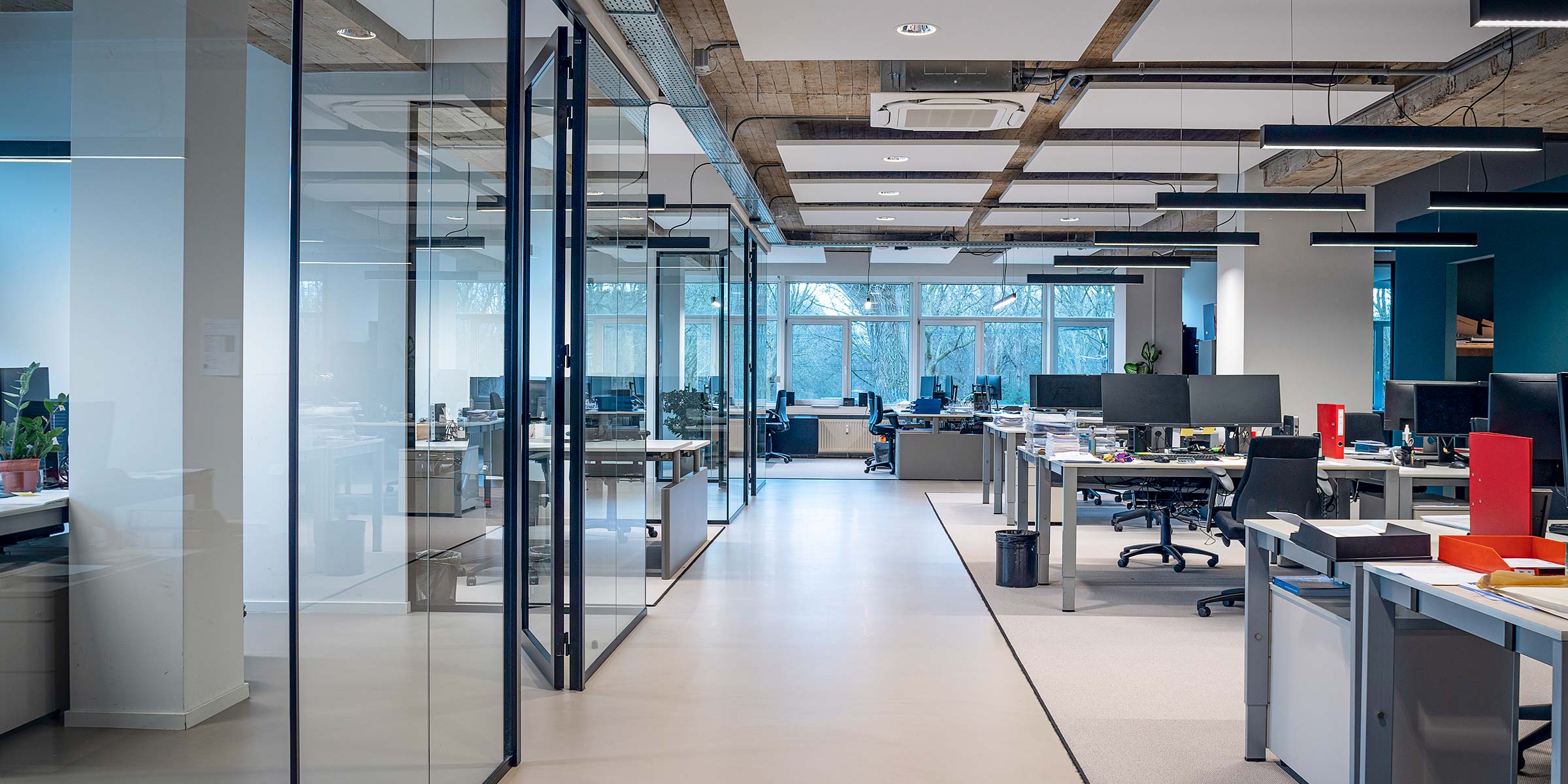 Spacious and modern AHP office with open workspace and glass meeting rooms, representing sourcing expertise and global network